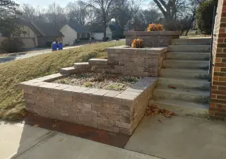 Front planter retaining wall with limestone cap and integrated bed